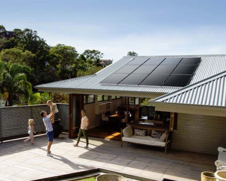 Solahart Silhouette solar panels on roof of house, with family playing in the foreground